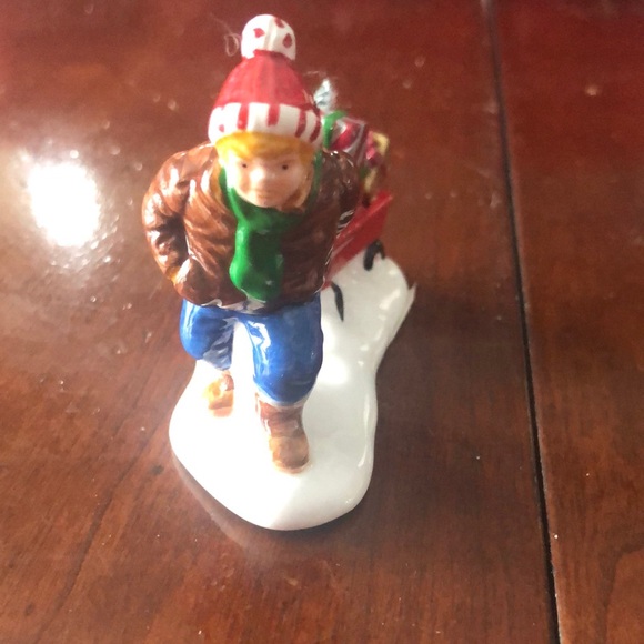 the boy pulling his sled of toys from Original Snow Village "Saturday Morning D - Picture 1 of 6